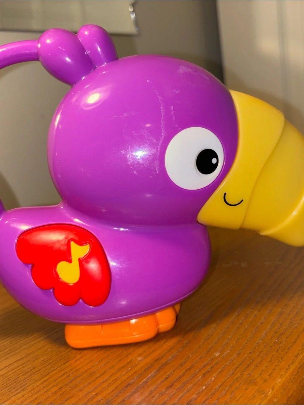 Fisher-Price Vibrant Purple Parrot Toy with Yellow Beak works great